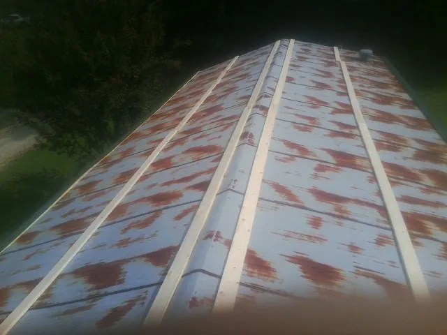 Rusted metal roof panels with new wood purlins before replacement — Storm Damage Roof Repair in Pinetops by Roofing Brothers